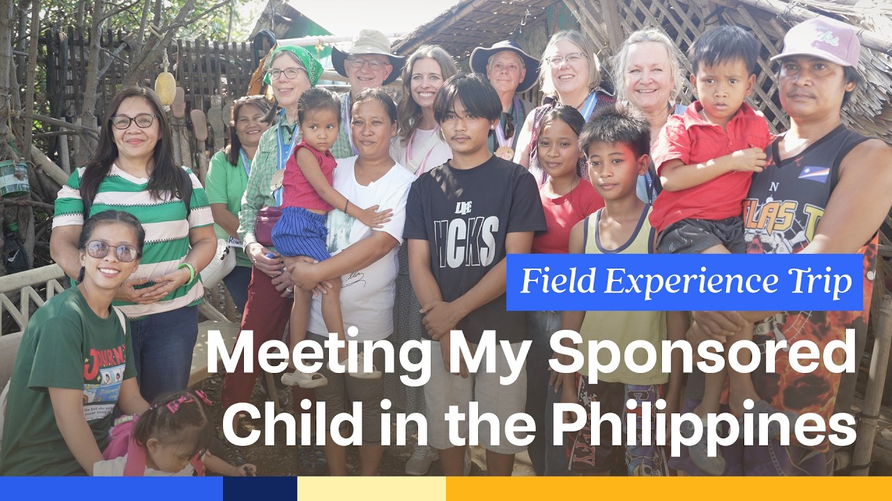 A group of people stand and smile at the camera in the Philippines.