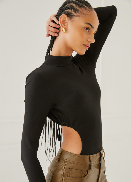 Model in Turtleneck Cut Out Bodysuit in Black