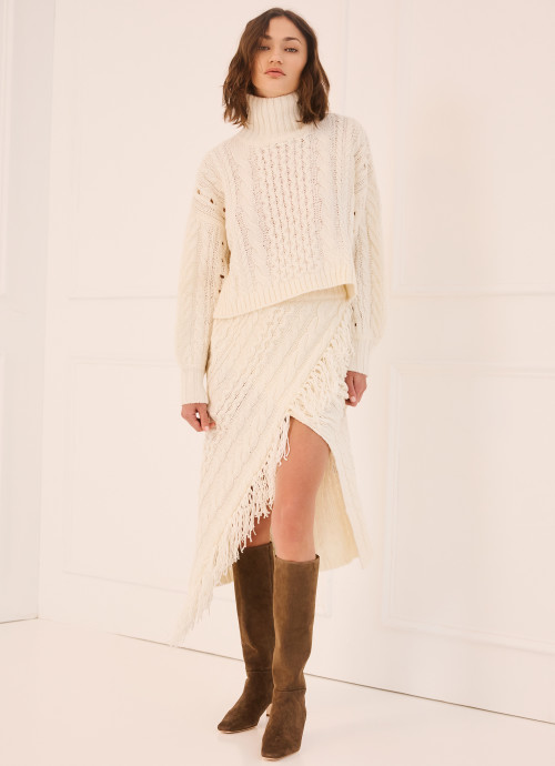 Model in Cableknit Turtleneck Sweater and Cableknit Sweater Skirt in Ivory