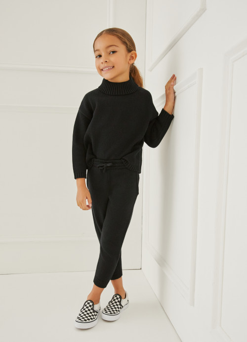 Model in Kids Turtleneck Sweater and Knit Joggers in Black
