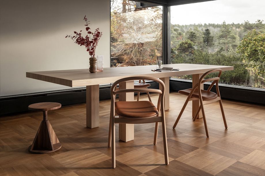 A lifestyle image of a dining scene featuring Max Table, Udon Chairs and All Wood Stool.