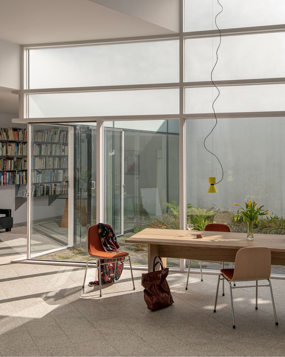A lifestyle image of a dining scene featuring Bookmatch Table, Touchwood Chairs and Alphabeta Pendant Lights.