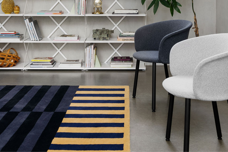 A lifestyle image of a lounge scene featuring Lift Shelf, Stripe Rug and Kendo Chair.