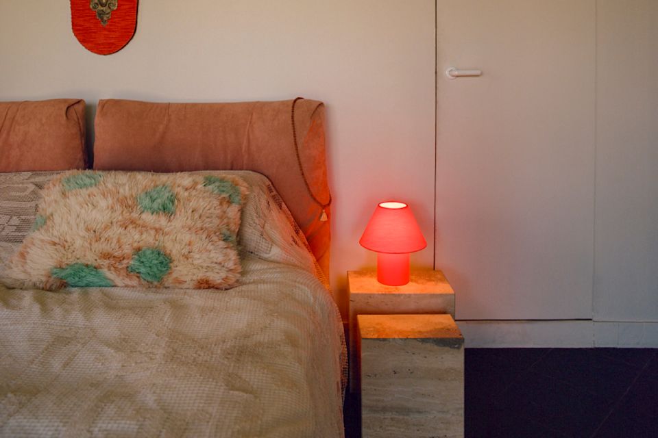 A lifestyle image of a bedroom scene featuring Monster Cushion Large and Toto Table Lamp Small.