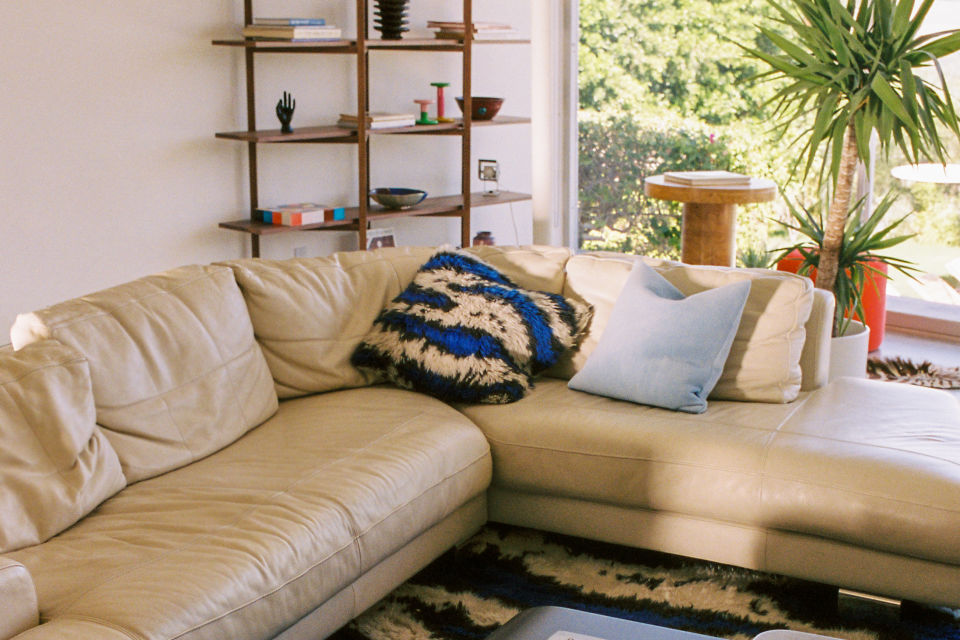 A lifestyle image of a living room/lounge scene featuring Monster Cushion Medium, Velvet Cushion Medium, and Zig Zag High Shelf.