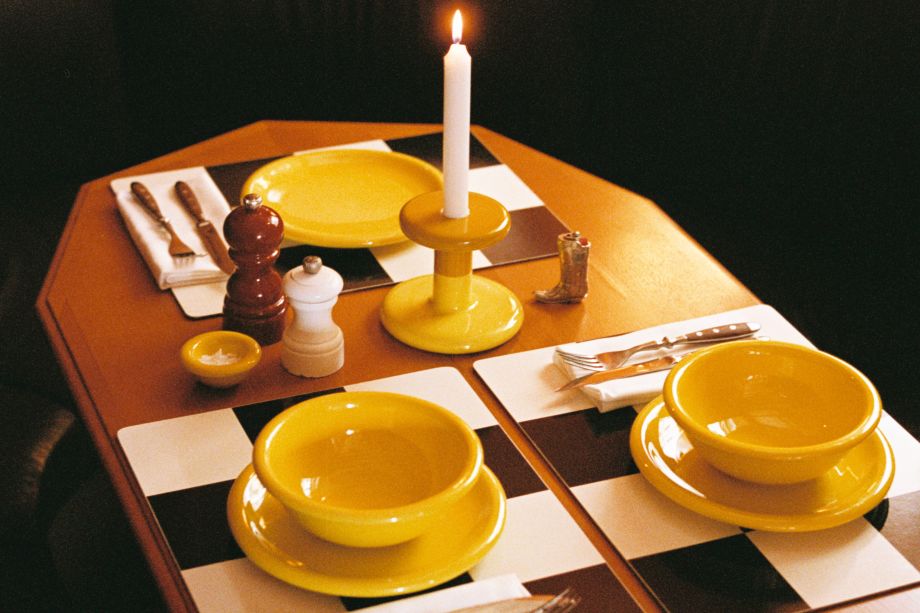 A lifestyle image of a dining scene featuring Bronto Bowls, Bronto Plates, Pesa Candle Holder, and Check Placemats.