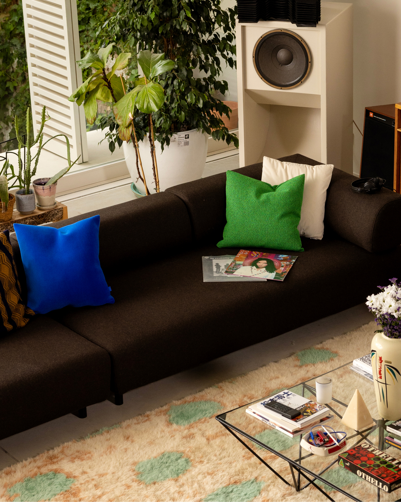 A lifestyle image of a living room/lounge scene featuring Palo Modular Sofa, Velvet Cushion Medium, Crepe Cushion Medium, and Monster Rug Extra Large.