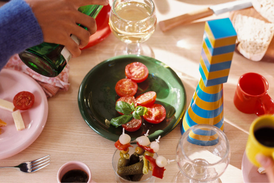 A lifestyle image of a dining scene featuring Bronto Tableware and Molino Grinder on top of a Max Table.