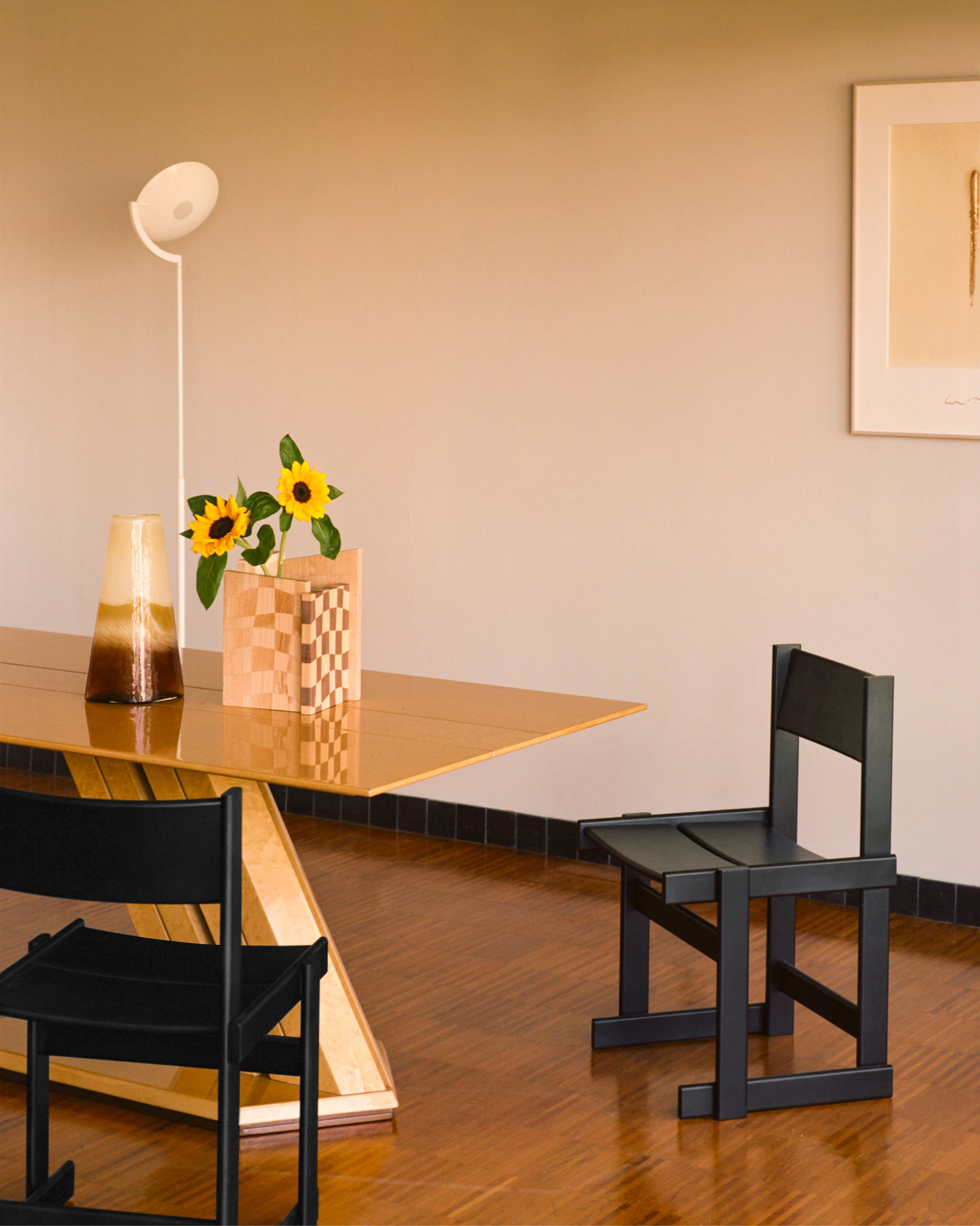A lifestyle image of a dining scene featuring Bullnose Chairs and Mix Wood Vessel.