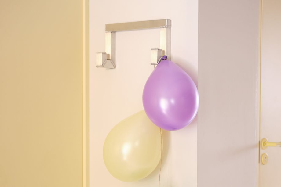 A lifestyle image featuring Tig Hook Double in a hallway with balloons hanging from it.