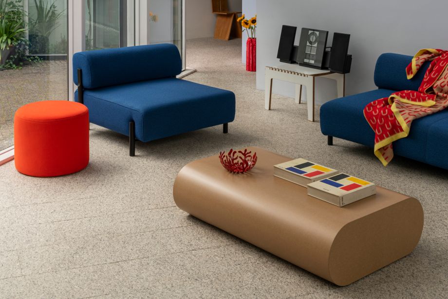 A lifestyle image of a living room scene featuring Palo Modular Sofa, Arch Throw, Stump Coffee Table and Bon Pouf Round.