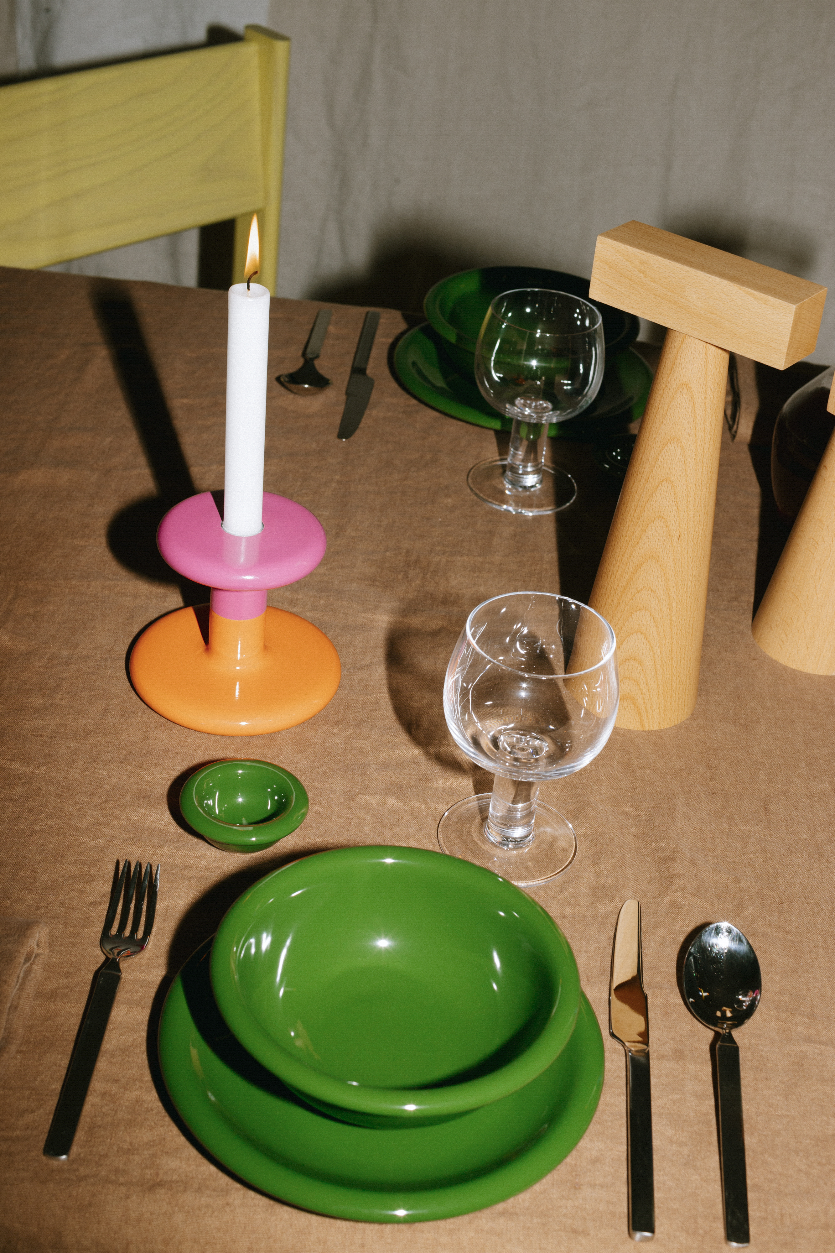 A lifestyle image of a dining scene featuring Molino Grinder, Pesa Candle Holder, Bronto Bowl, Bronto Plate, Bronto Egg Cup, and Fars Glas.