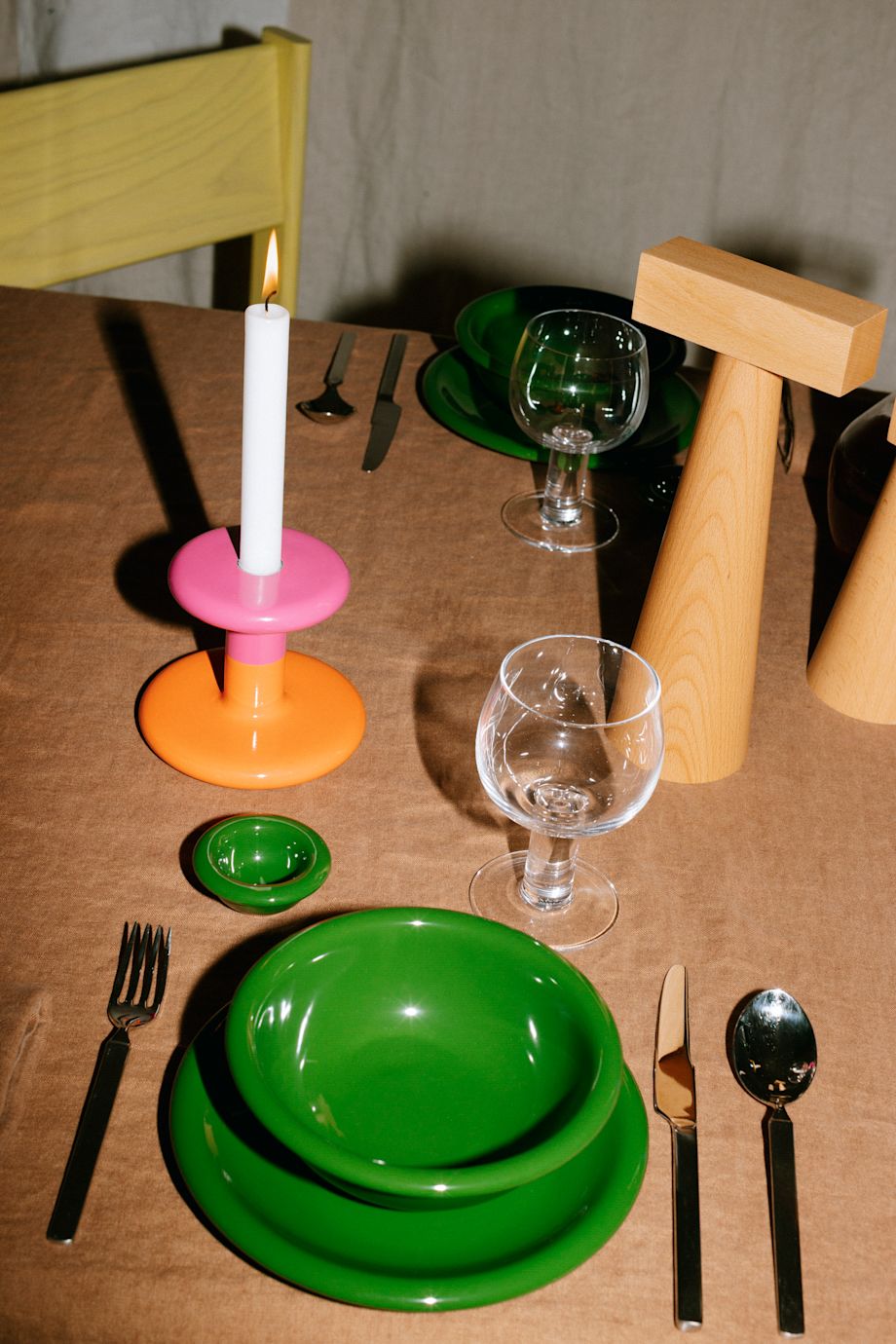 A lifestyle image of a dining scene featuring Molino Grinder, Pesa Candle Holder, Bronto Bowl, Bronto Plate, Bronto Egg Cup, and Fars Glas.