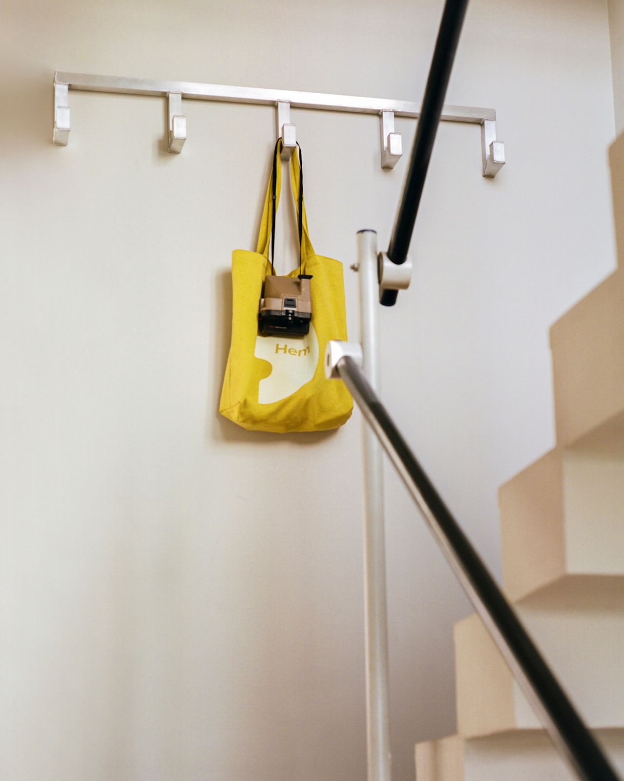 A lifestyle image of a hallway/entryway featuring Tig Hook Quintuple by designer Kwangho Lee.