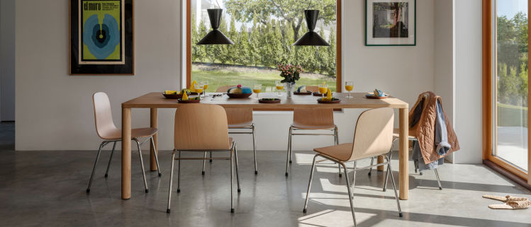 A lifestyle image of a dining scene featuring Touchwood Chairs, Alphabeta Pendant Lights, and Log Table.