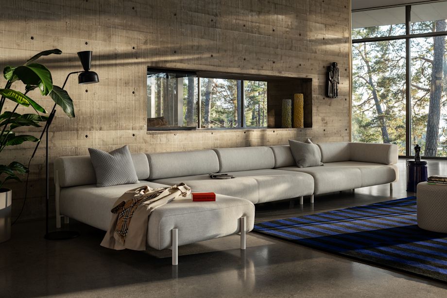 Lifestyle image of a living room scene featuring Palo Sofa, Dash Cushion, Stripe Rug and Last Stool.