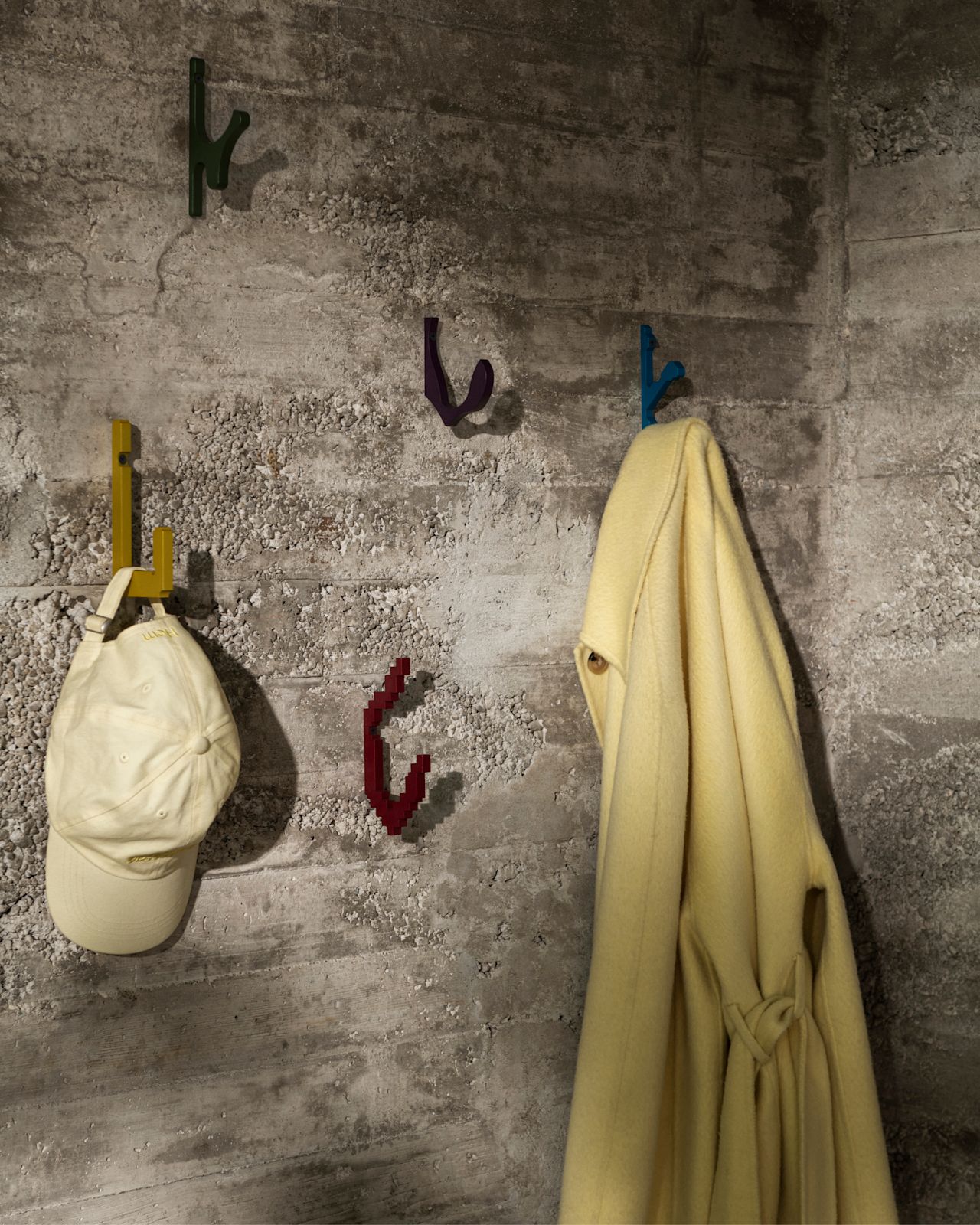 A lifestyle image featuring Hooked! Set of 5 limited editions hanging on a grey wall.