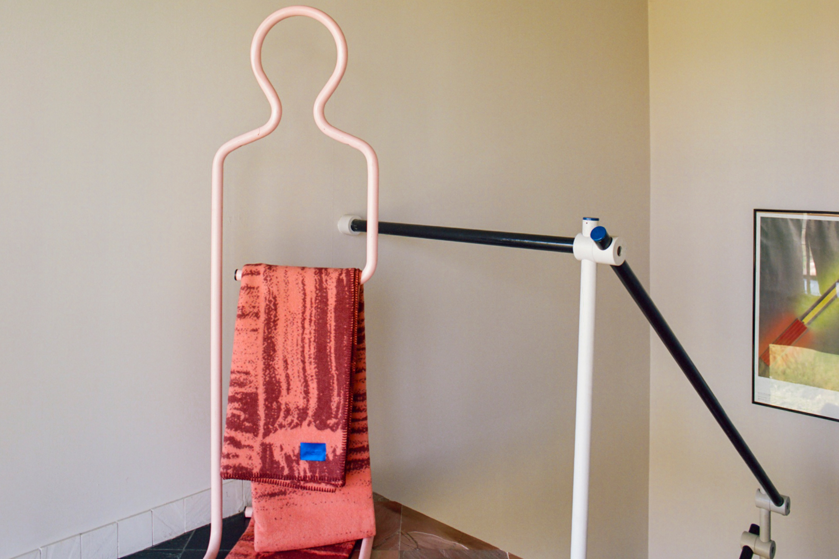 A lifestyle image of a hallway/entryway featuring Glitch Throw Coral / Rust Red.