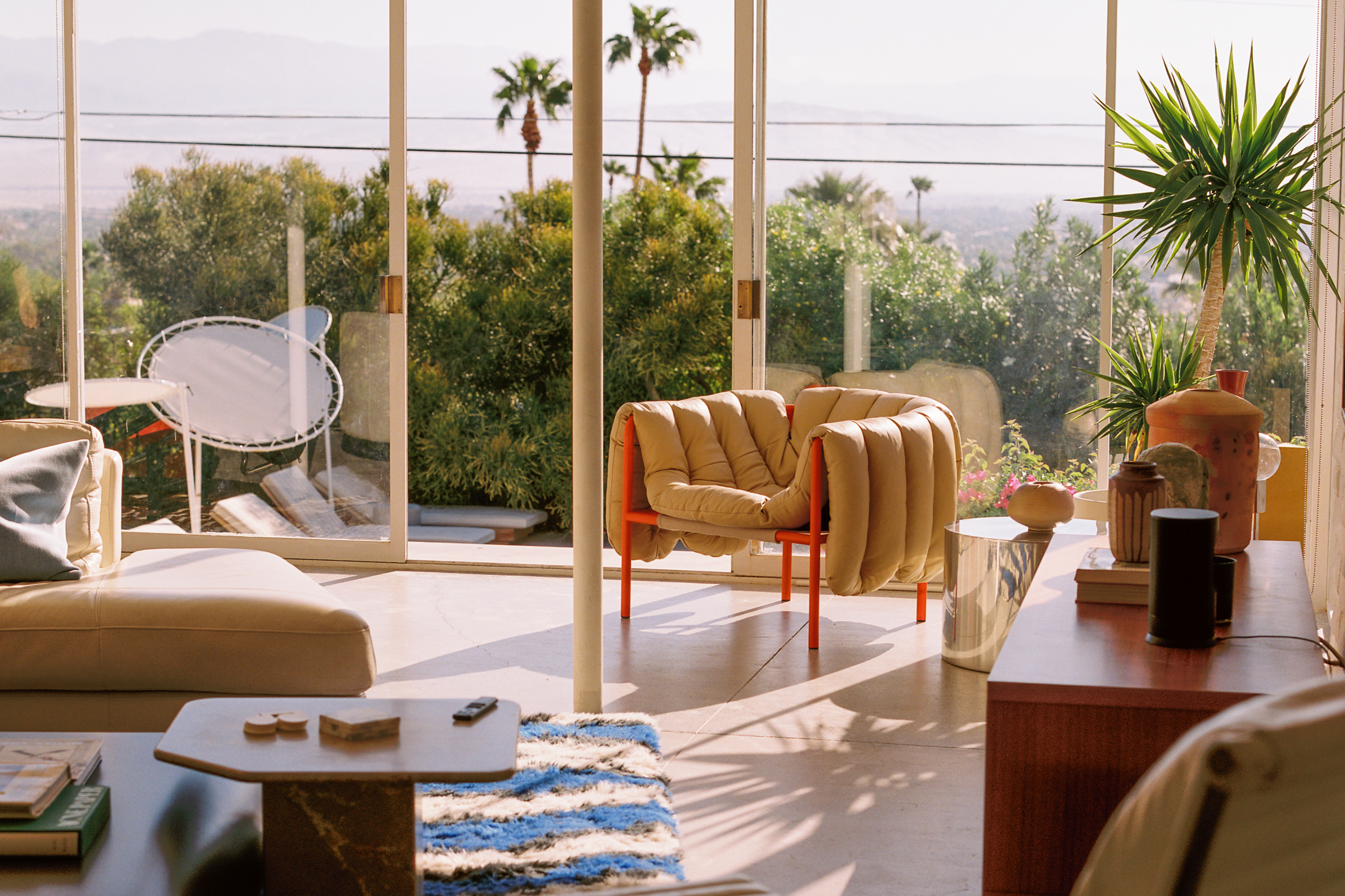 A lifestyle image of a lounge scene featuring Puffy Lounge Chair, Monster Rug, and more.