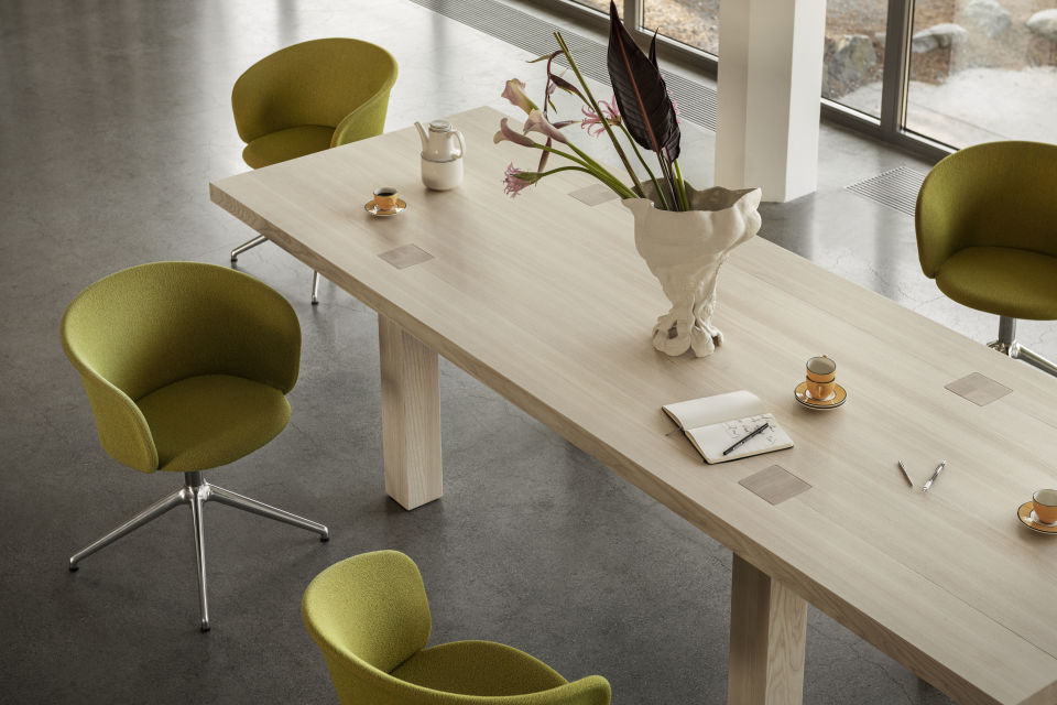 Lifestyle image of an office scene featuring Kendo Chairs and Max Table.