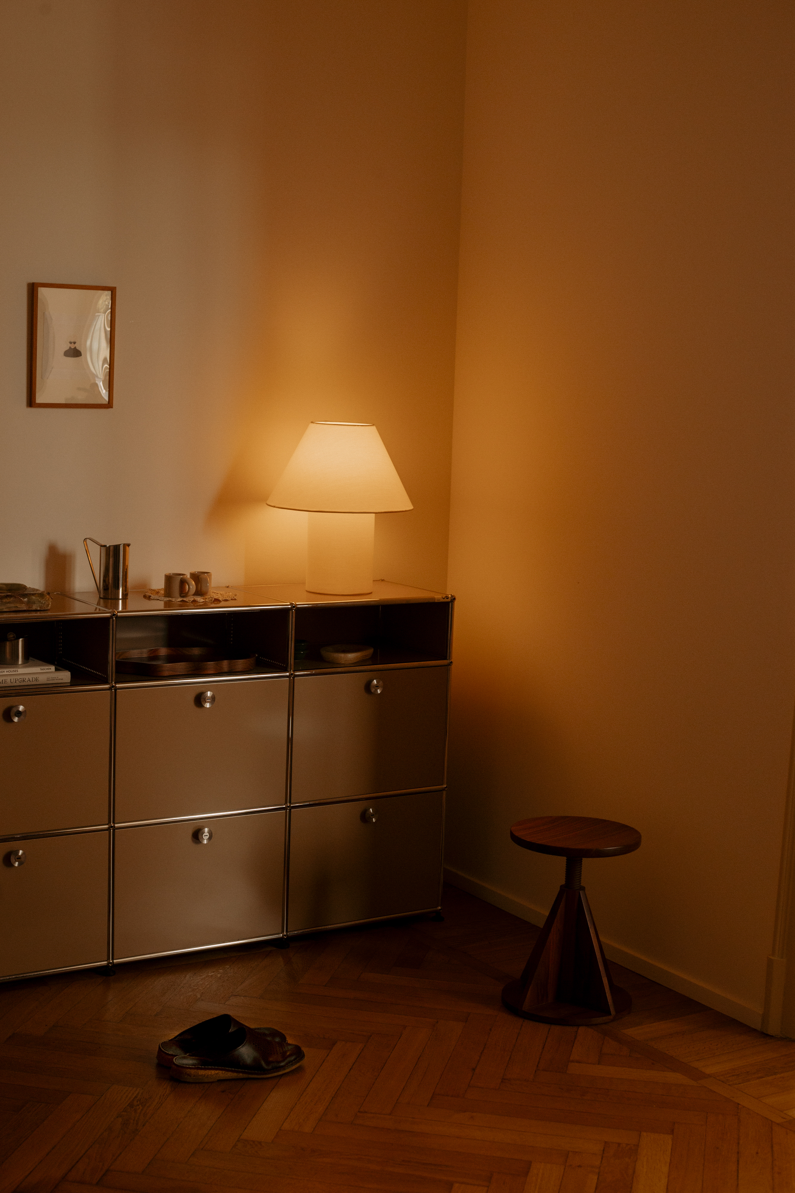 A lifestyle image featuring All Wood Stool, Toto Table Lamp Medium, and Bronto Espresso Cups.