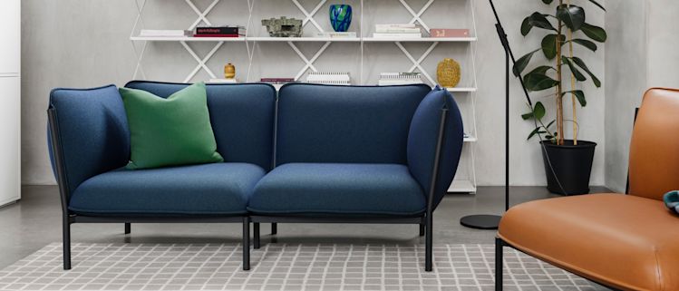 Hem - A living room scene featuring Kumo Sofa, Neo Cushion, Vienna Throw, Grid Rug, and Lift Shelf.