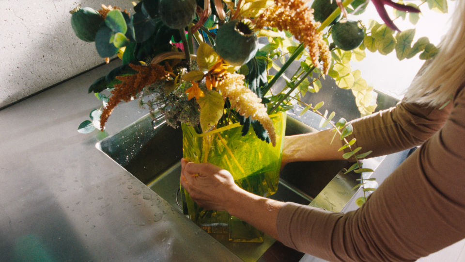 A lifestyle image of a kitchen scene featuring Brute Vase with flowers.