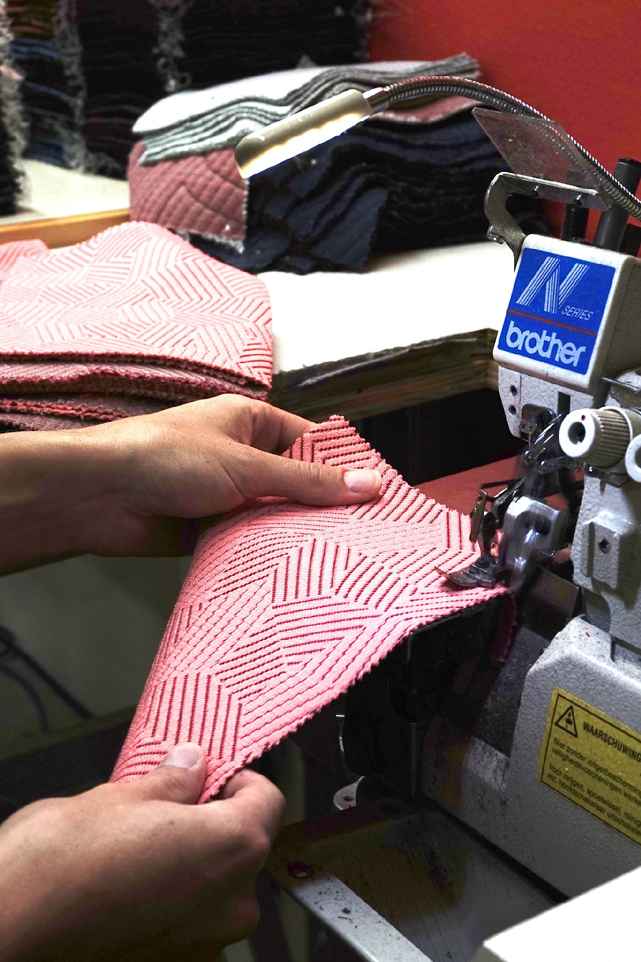An editorial image from behind the scenes of the factory that makes the fabric for Hem's Hai Lounge Chairs and Bon Poufs.