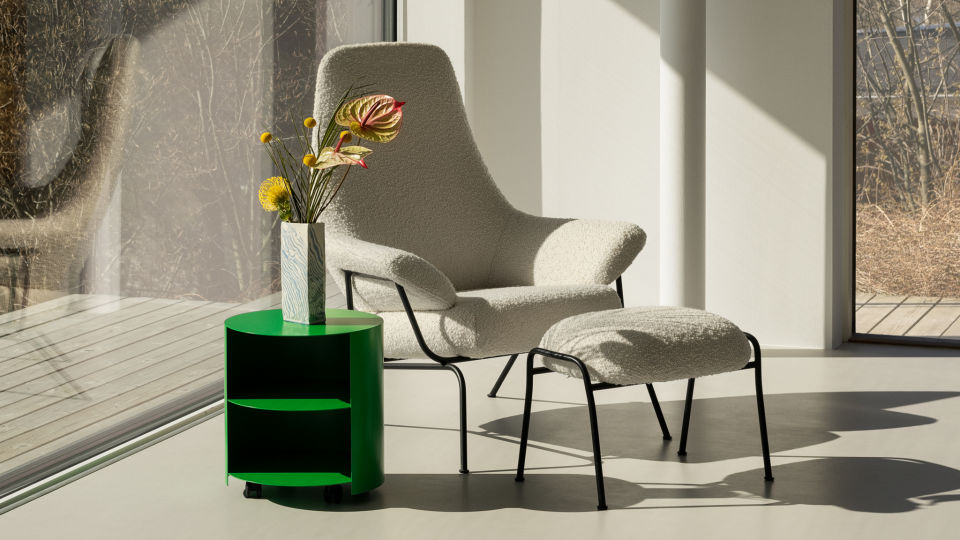 Lifestyle image featuring Hai Lounge Chair + Ottoman in Eggshell and Hide Side Table Pure Green.