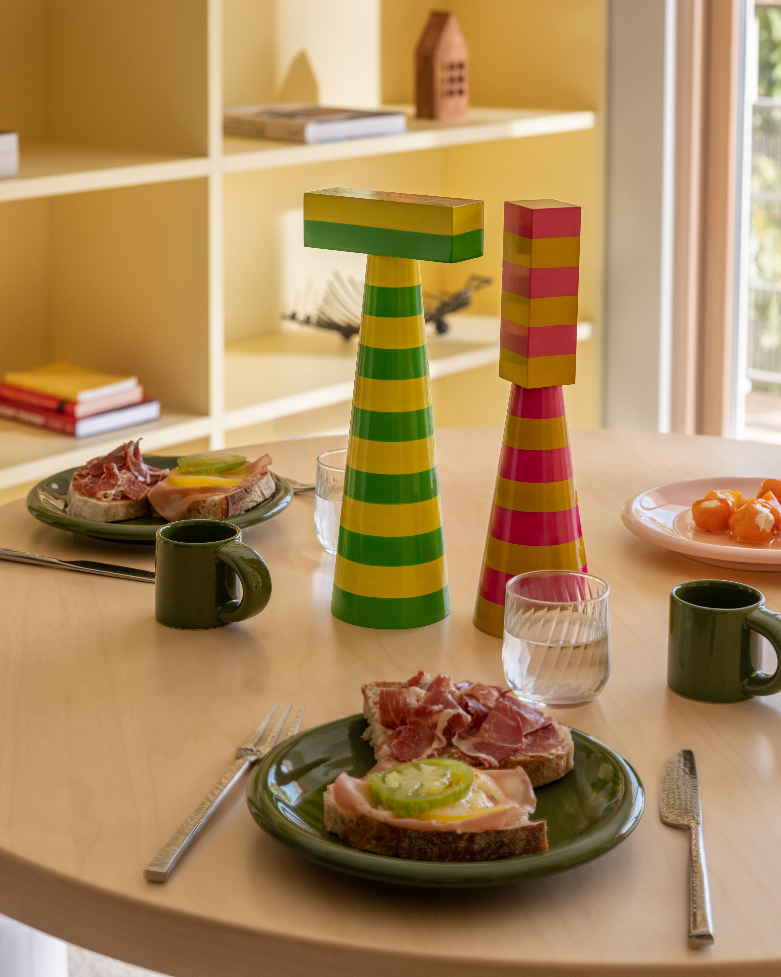 A lifestyle image of a dining scene featuring Molino Grinders and Bronto Tableware.