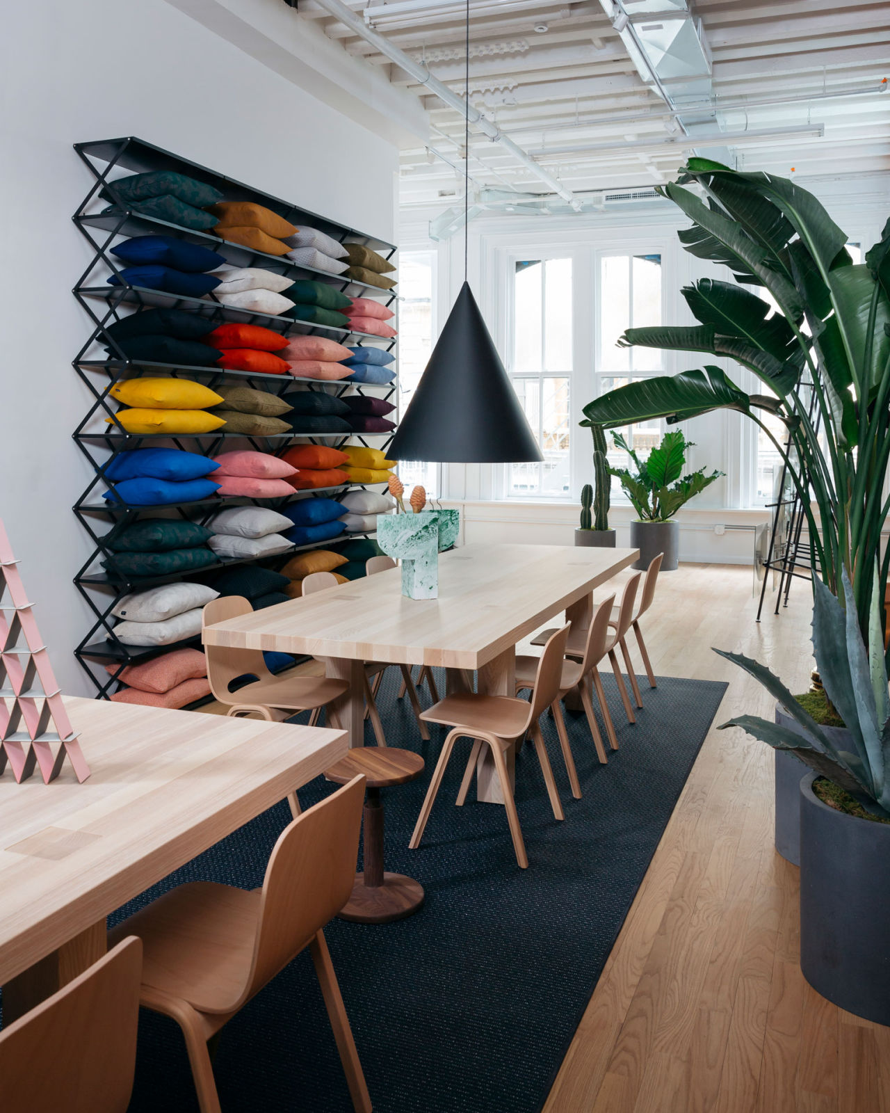 An editorial image from Hem's NY studio / showroom featuring Max Table, Touchwood Chairs, Storm Cushions and Powder Vase.