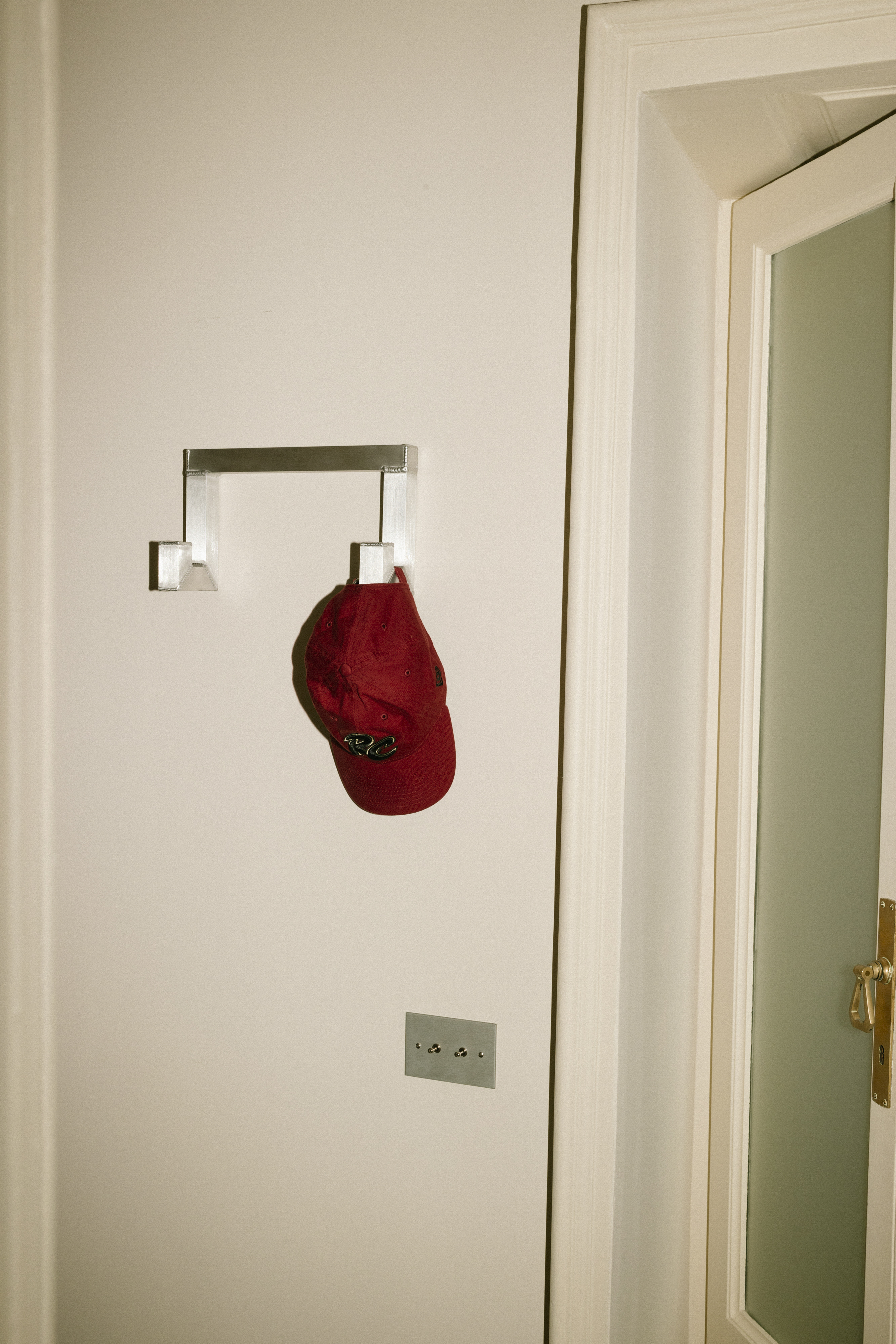 A lifestyle image of a hallway scene featuring Tig Hook Double by designer Kwangho Lee.