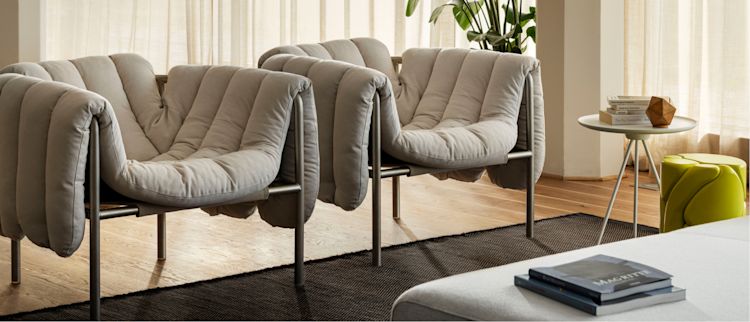 Hem - A living room scene featuring two Puffy Lounge Chairs, Dune Rug, Palo Sofa, and Key Side Table.