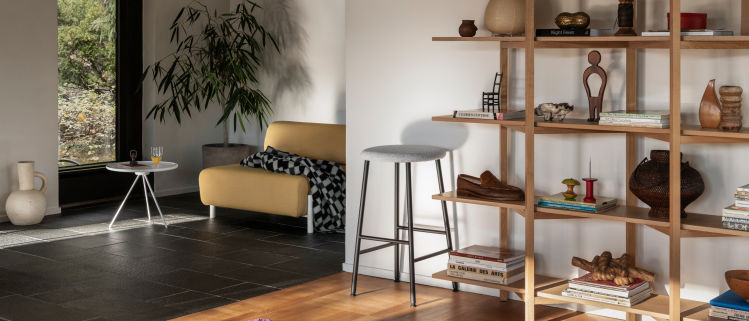 Hem - A living room scene featuring Key Coffee Table, Palo Single Seater, Vienna Throw, Kendo Counter Stool, and Zig Zag High Shelf in Oak.