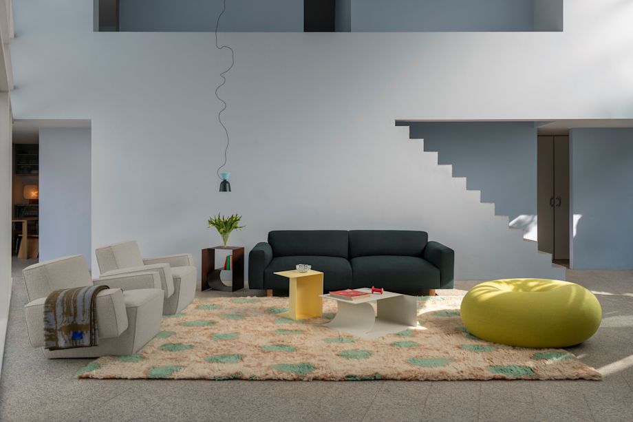A lifestyle image of a living room scene featuring Hunk Lounge Chair, Monster Rug, Glitch Throw, Alphabeta Pendant Light, Glyph Side Tables, Boa Pouf and Koti Sofa.