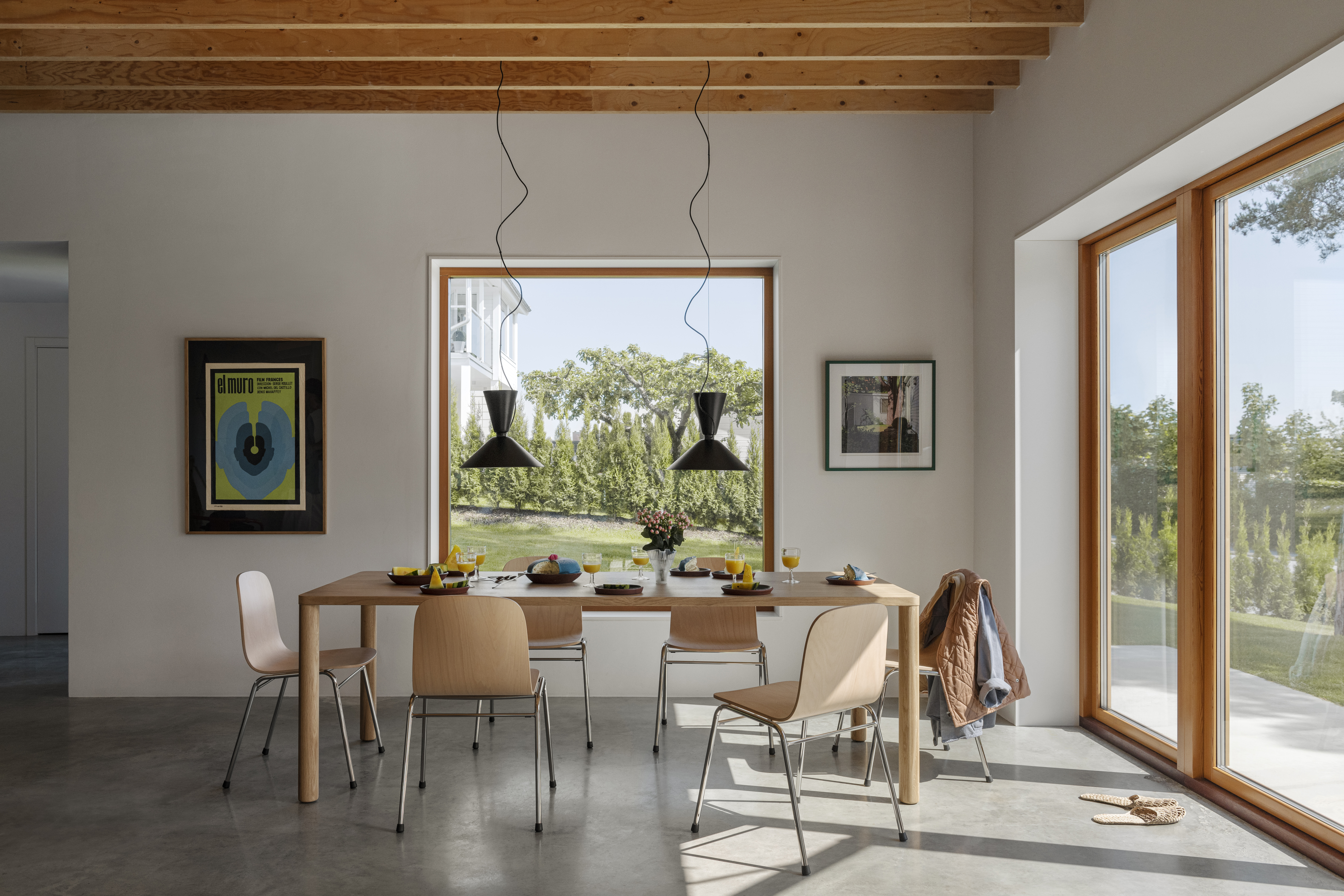 A lifestyle image of a dining scene featuring Log Table, Alphabeta Pendants, and Touchwood Chairs.