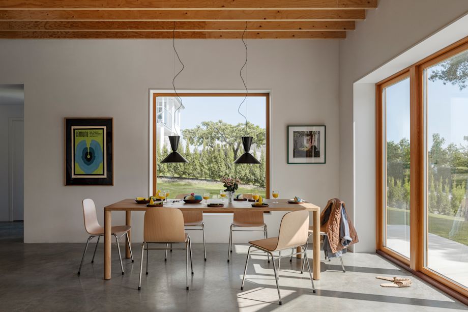 A lifestyle image of a dining scene featuring Log Table, Alphabeta Pendants, and Touchwood Chairs.
