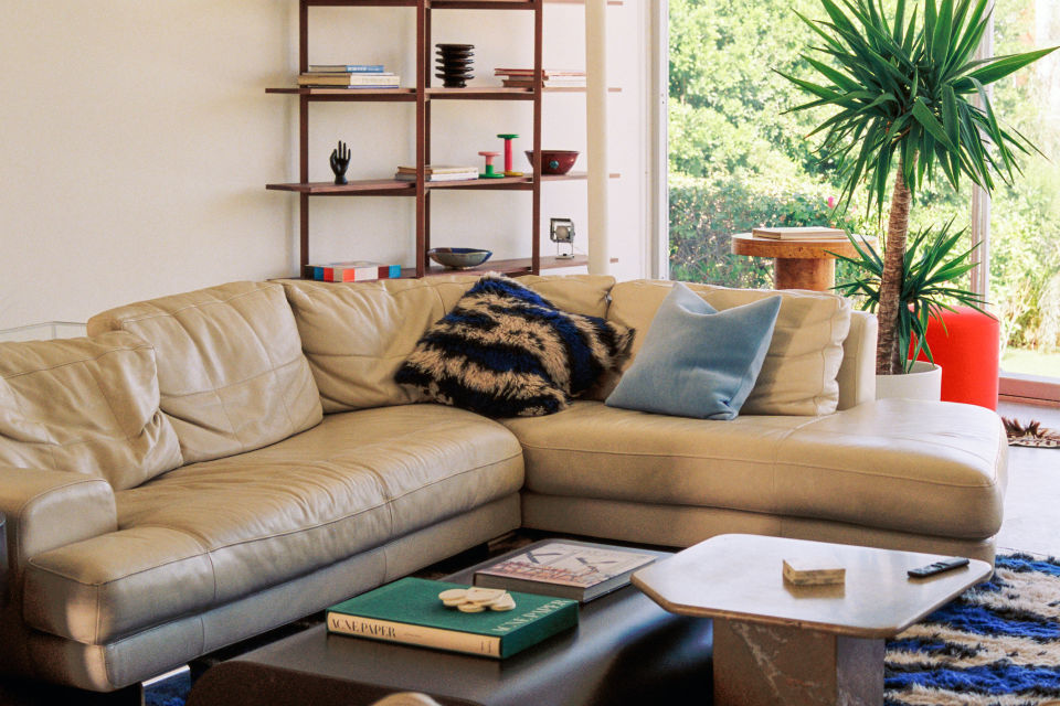 A lifestyle image of a living room scene featuring Velvet Cushion Medium, Monster Cushion Medium, Zig Zag High Shelf, Monster Rug, and Stump Coffee Table Large.
