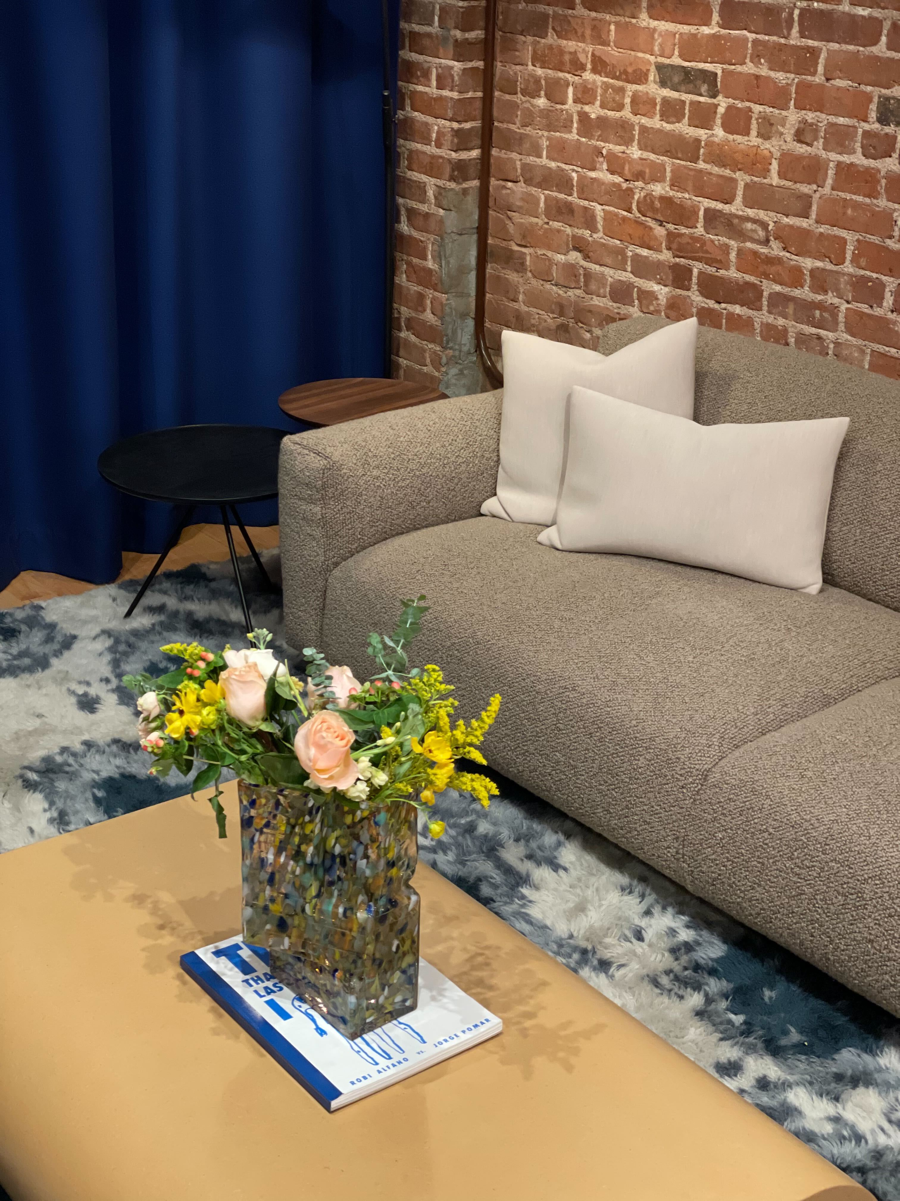 An editorial image from our NYC showroom featuring Stump Coffee Table, Brute Vase, Monster Rug, Koti Sofa, Key Coffee Table, Key Side Table, and Neo Cushions.