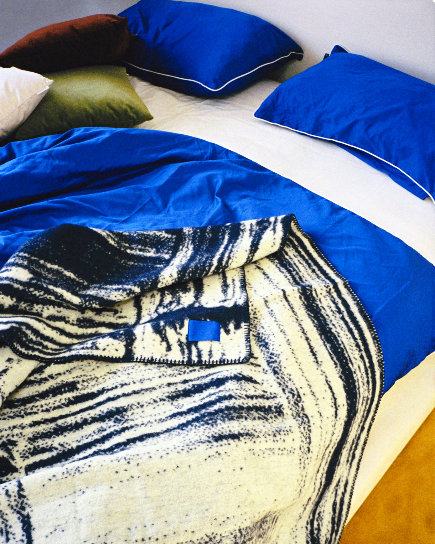 A lifestyle image of a bedroom scene featuring Glitch Throw.