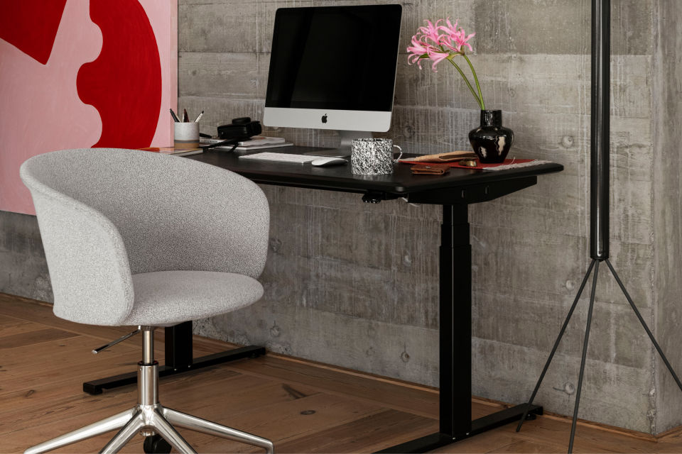 A lifestyle image of an office scene featuring Alle Height Adjustable Desk and Kendo Swivel Chair 5-star Castors.