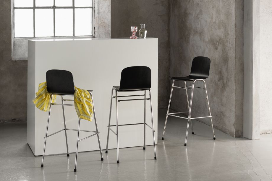 A lifestyle image of a bar scene featuring three Touchwood Bar Chairs in Black / Chrome.