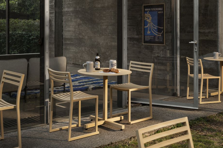 A lifestyle image of an outdoor patio scene featuring Chop Table Round Beige and Chop Chairs Beige.