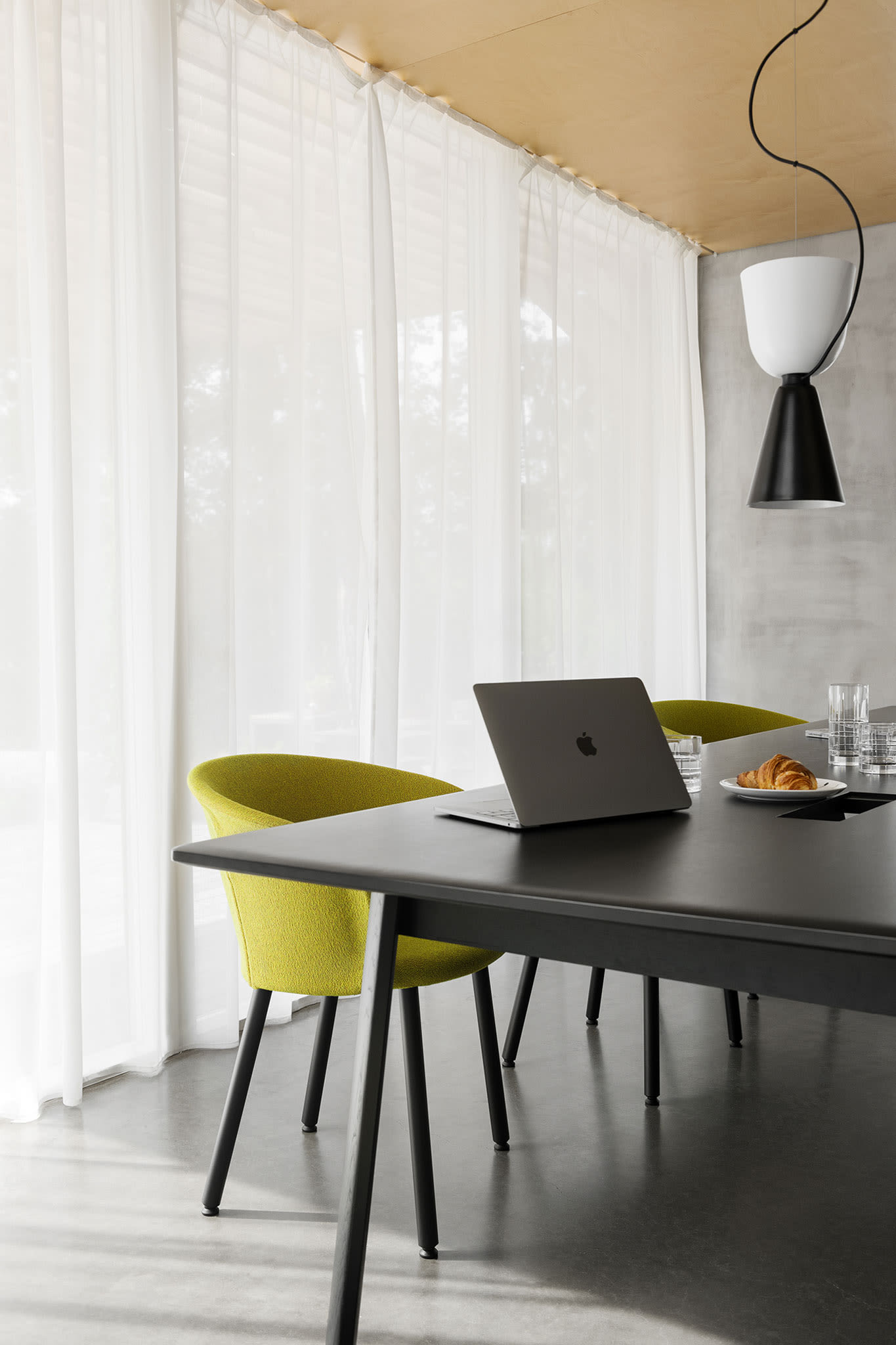 A lifestyle image of an office / dining scene featuring Kendo Chair, Alphabeta Pendant Light and Alle Table.