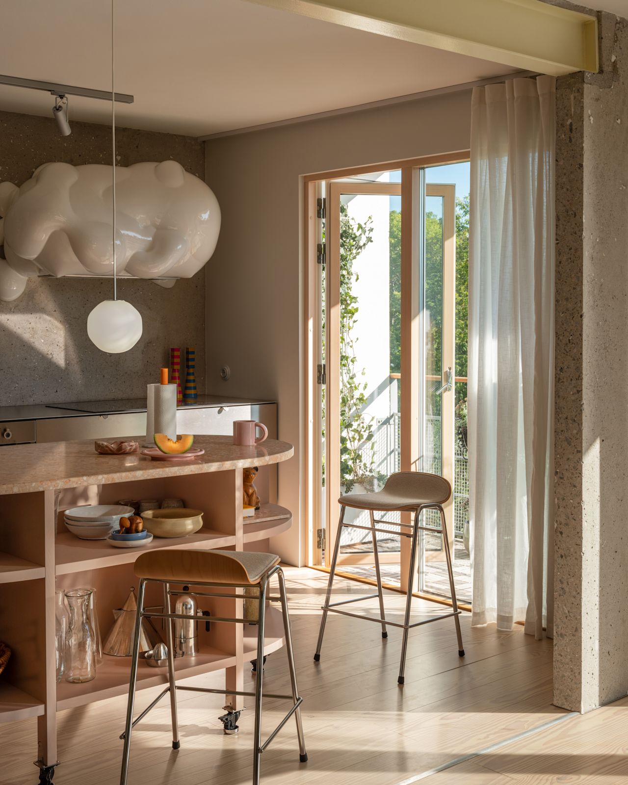 A lifestyle image of a kitchen scene featuring Touchwood Counter Stools, Coco Pendant Light, Bronto Tableware, Spill Kitchen Roll Holder, and Molino Grinder.