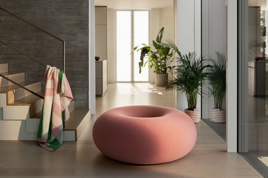 Hem - Boa Pouf in Cotton Candy featured in a hallway with a staircase on the side with a Stripe Throw in Pink / Green draped over the handrail.