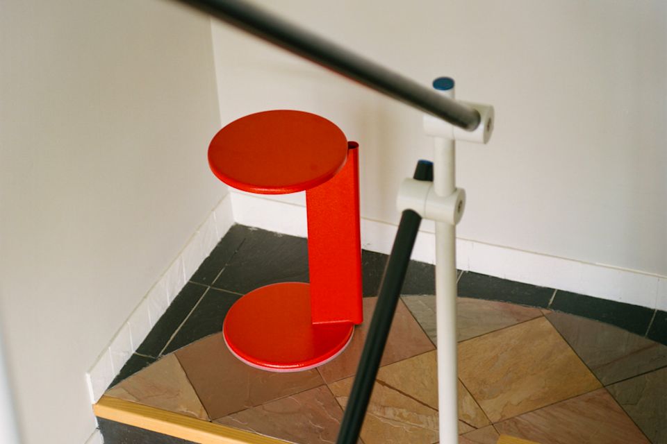 A lifestyle image of a hallway scene featuring Lolly Side Table Traffic Red.