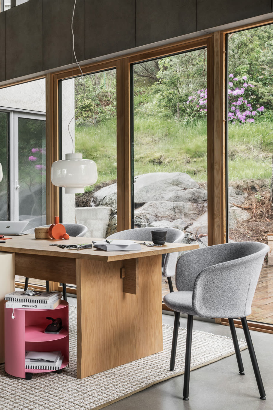 A lifestyle image of an office / dining scene featuring Bookmatch Table, Dusk Lamp, Rope Rug, Hide Side Table, and Kendo Chair.