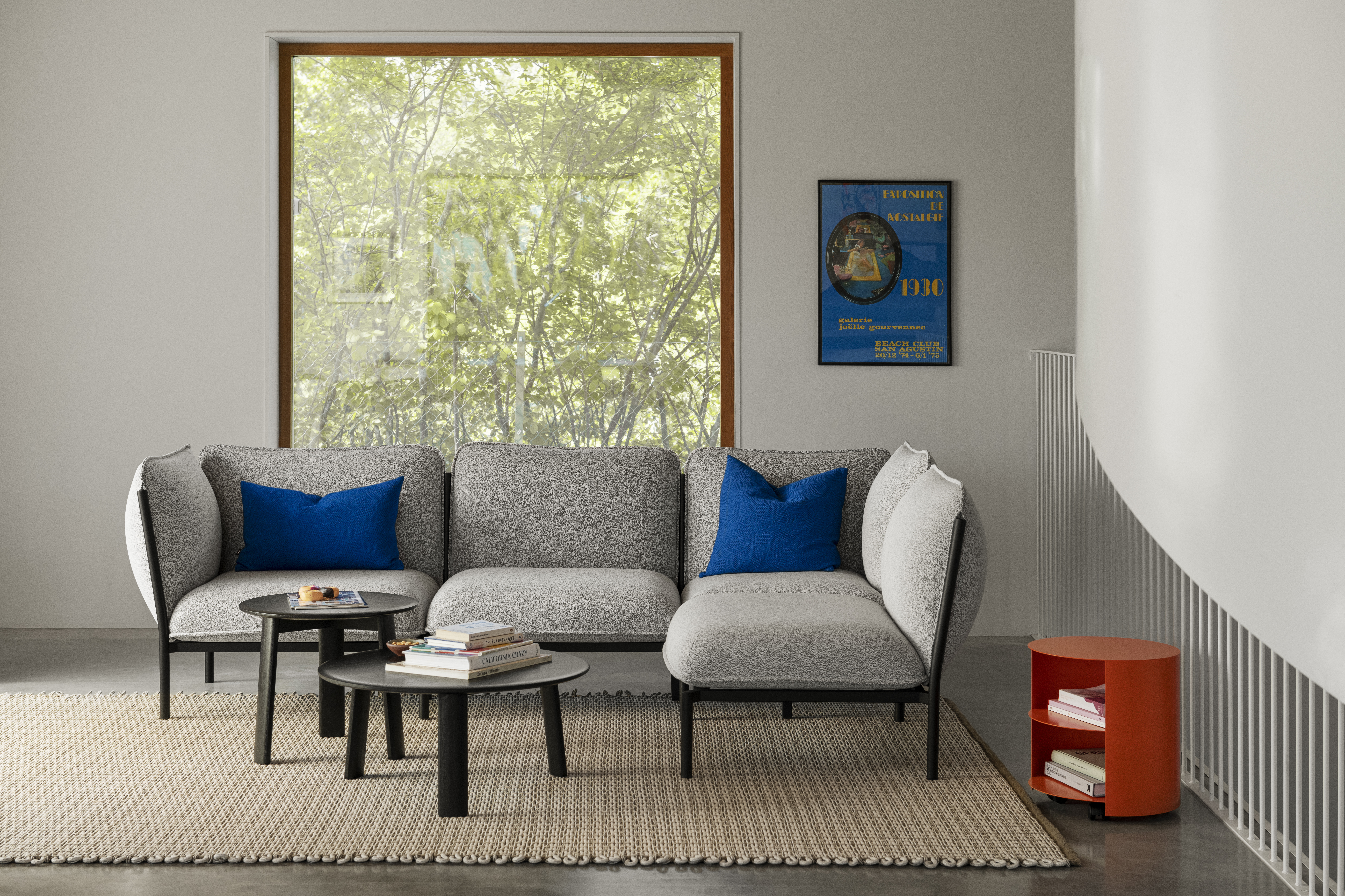 A lifestyle image of a living room/lounge scene featuring Rope Rug, Kumo Sofa, Alle Coffee Tables, Hide Side Table, and Storm Cushions.