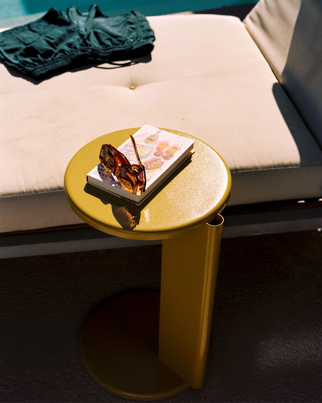 A lifestyle image of a patio scene featuring Lolly Side Table Ochre Yellow.